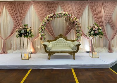 couch and flower arch with drapes